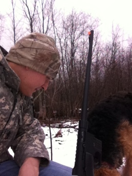 The author takes a break from the pursuit of  late season Snow Shoe Hares with his young Airedale Terrier, Jazmyn.